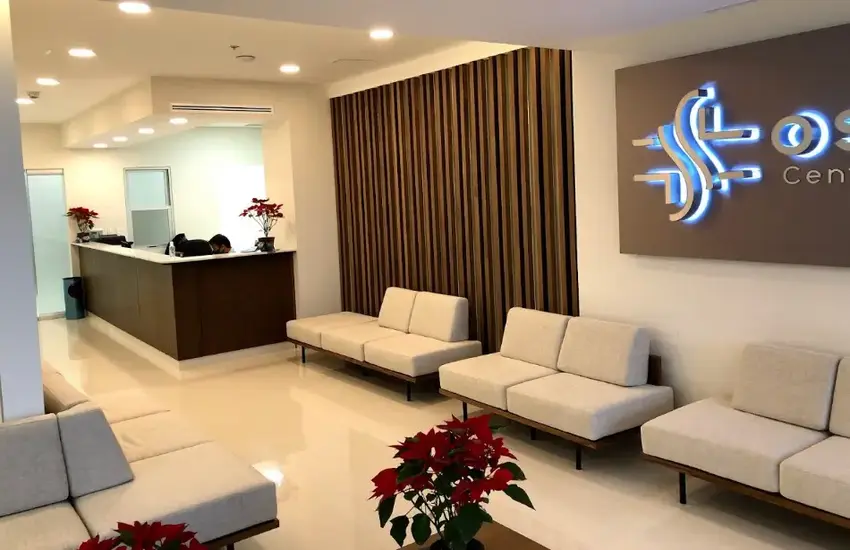 Reception room in predominantly white with Ossis logo